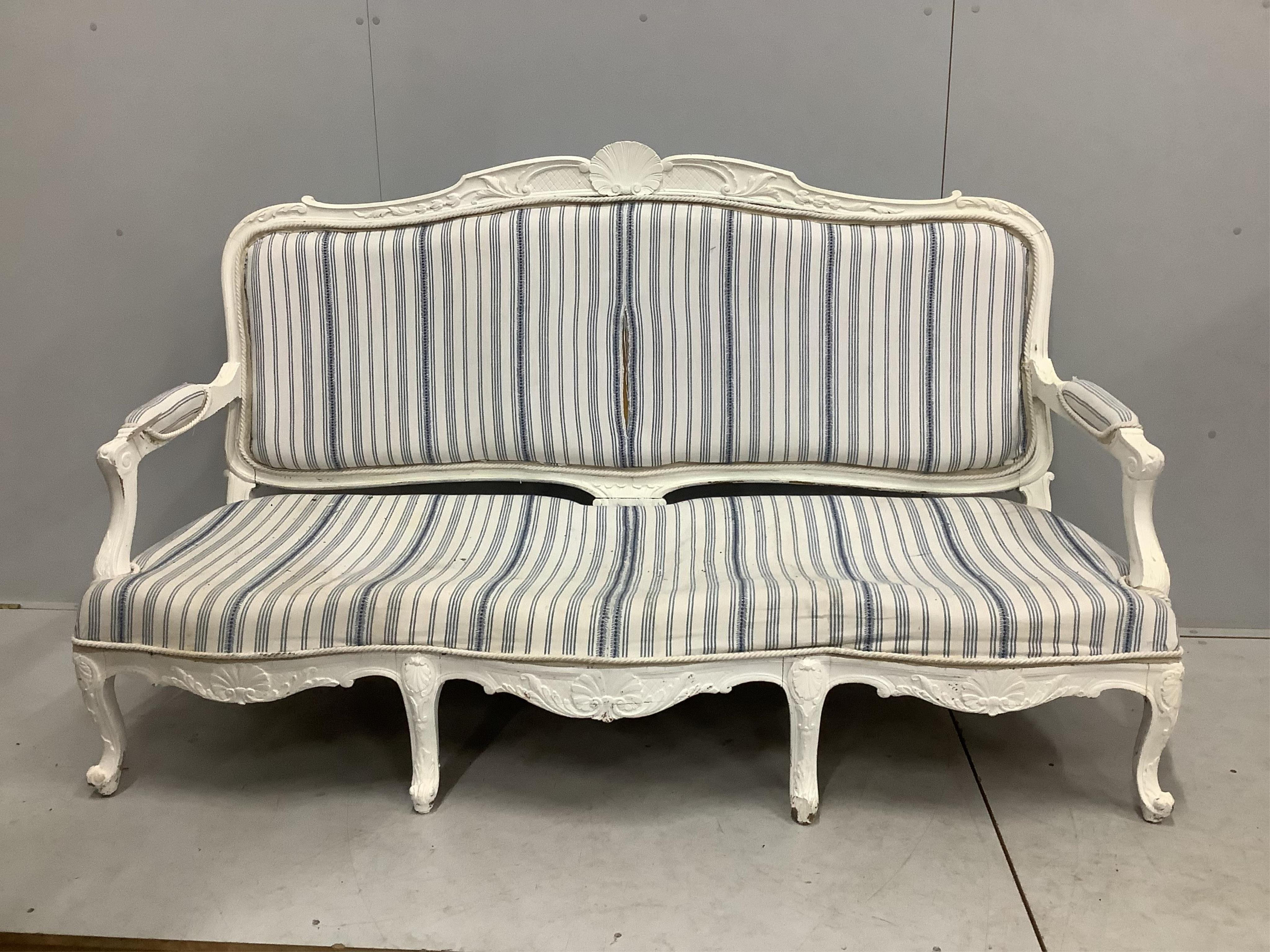 A Louis XVI style painted upholstered settee, width 180cm, depth 66cm, height 98cm. Condition - fair, upholstery poor